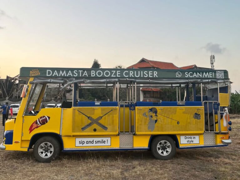 Full side view of the yellow Damasta Booze Cruiser with blue seats and branded roof signage.