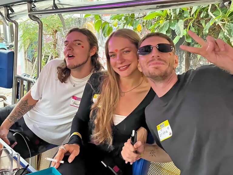 Three guests posing inside Damasta Booze Cruiser, with one wearing sunglasses and making a peace sign.